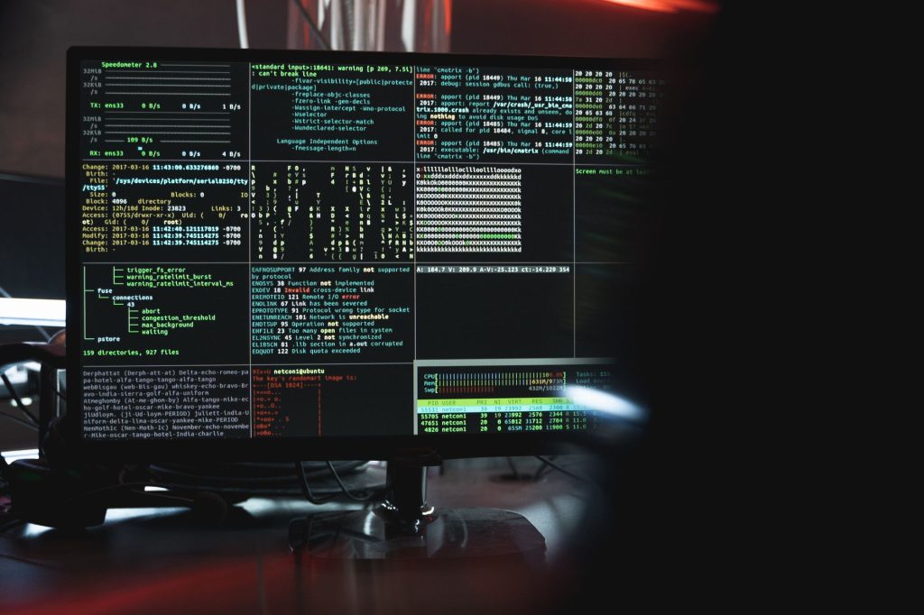 pexels-photo-5380664jpg - StakeProSoft Dark computer monitor displaying terminal output with green and red code lines, representing network request monitoring and anti-blocking strategies for VPS bots.