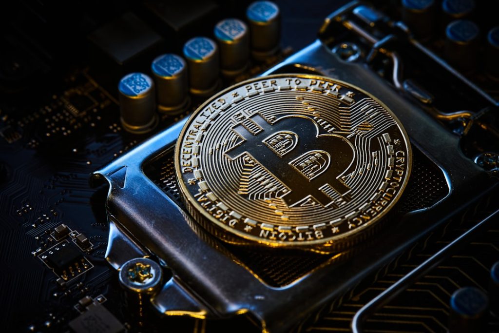 photo-1641580529558-a96cf6efbc72jpg - StakeProSoft Bitcoin coin resting on a computer motherboard, representing crypto casino bot game types
