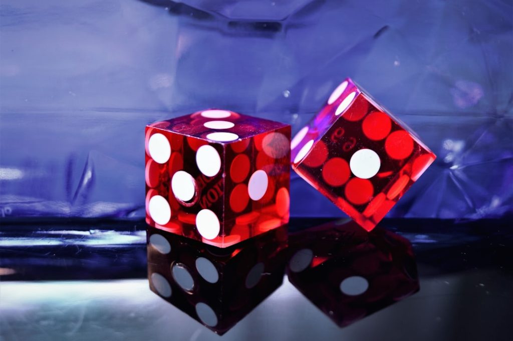 photo-1522617889820-47708e025180jpg - StakeProSoft Two red translucent casino dice with reflective surface, representing Martingale and Fibonacci betting progressions
